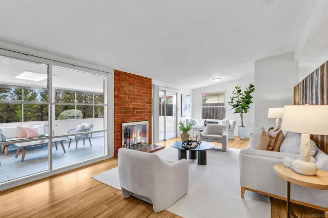 a living room with furniture large wooden floor and a fireplace