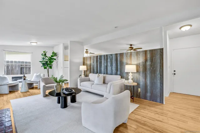 a living room with furniture and wooden floor