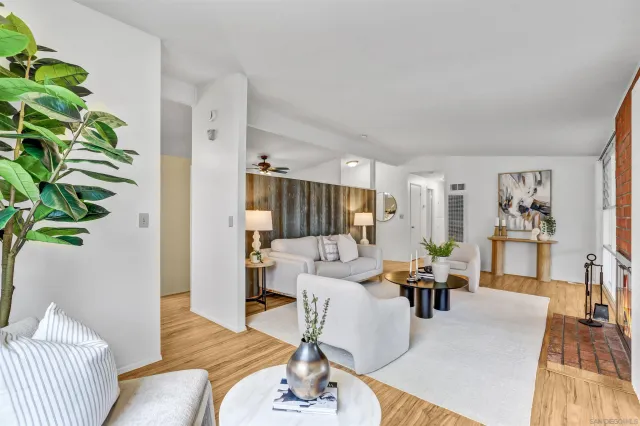 a living room with furniture a table and a potted plant