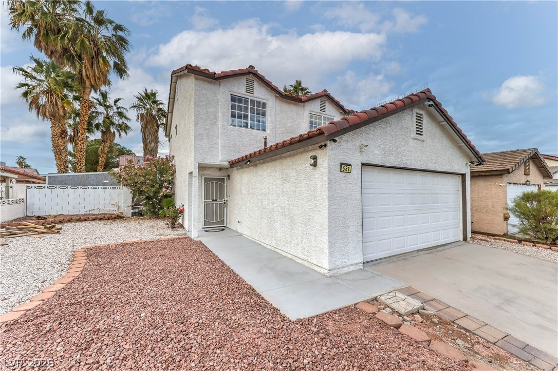 581 Carleton Drive Henderson, NV 89014 - Photo 3 of 37 A well-maintained stucco facade with a terracotta-tiled roof and an integrated garage awaits.