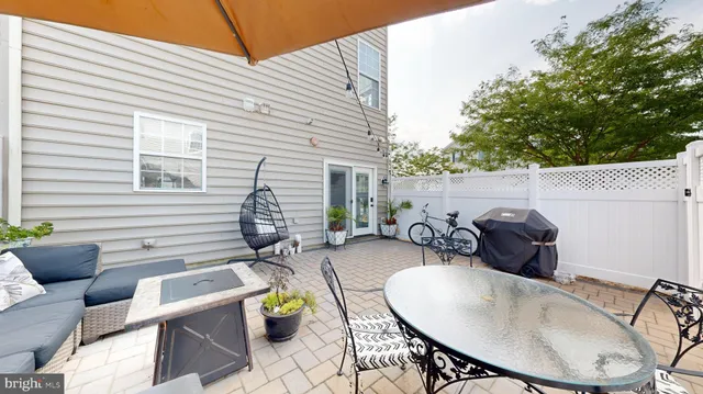 a view of a living room with wooden floor and stairs