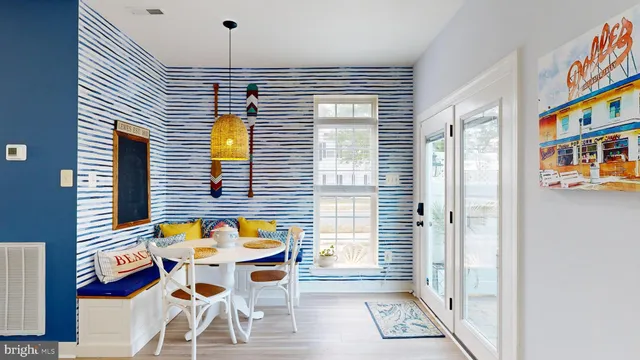 a view of a dining room with furniture and a window
