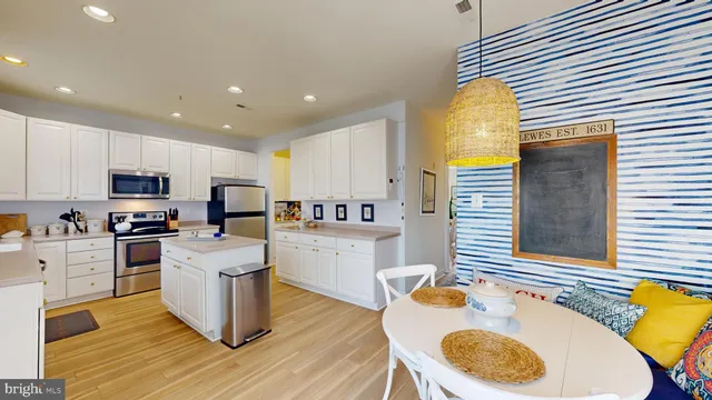 a kitchen with sink a stove and chairs