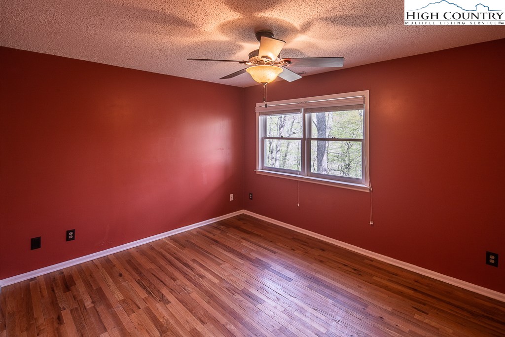 1135 Hopewell Church Road Boone, NC 28607 - Photo 8 of 21 a view of empty room with wooden floor and fan