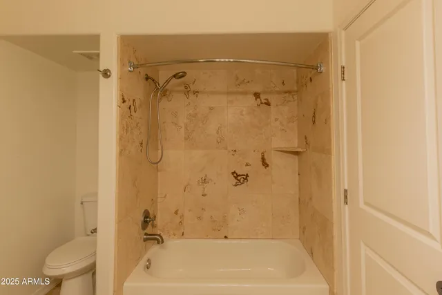 a bathroom with a shower and a toilet