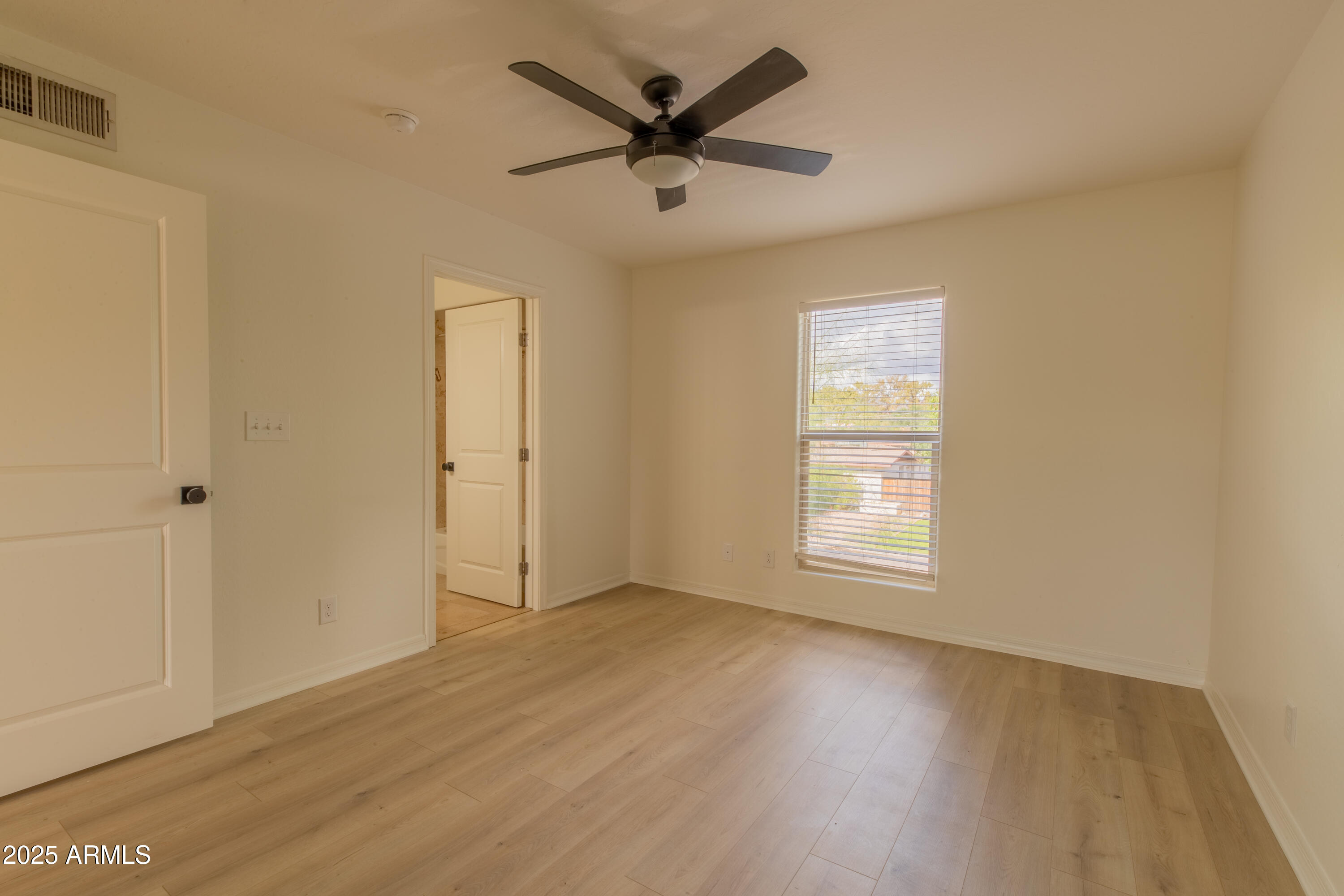 3619 East Monterosa Street, Unit 202 Phoenix, AZ 85018 - Photo 14 of 20 a view of a livingroom with a hardwood floor and a ceiling fan