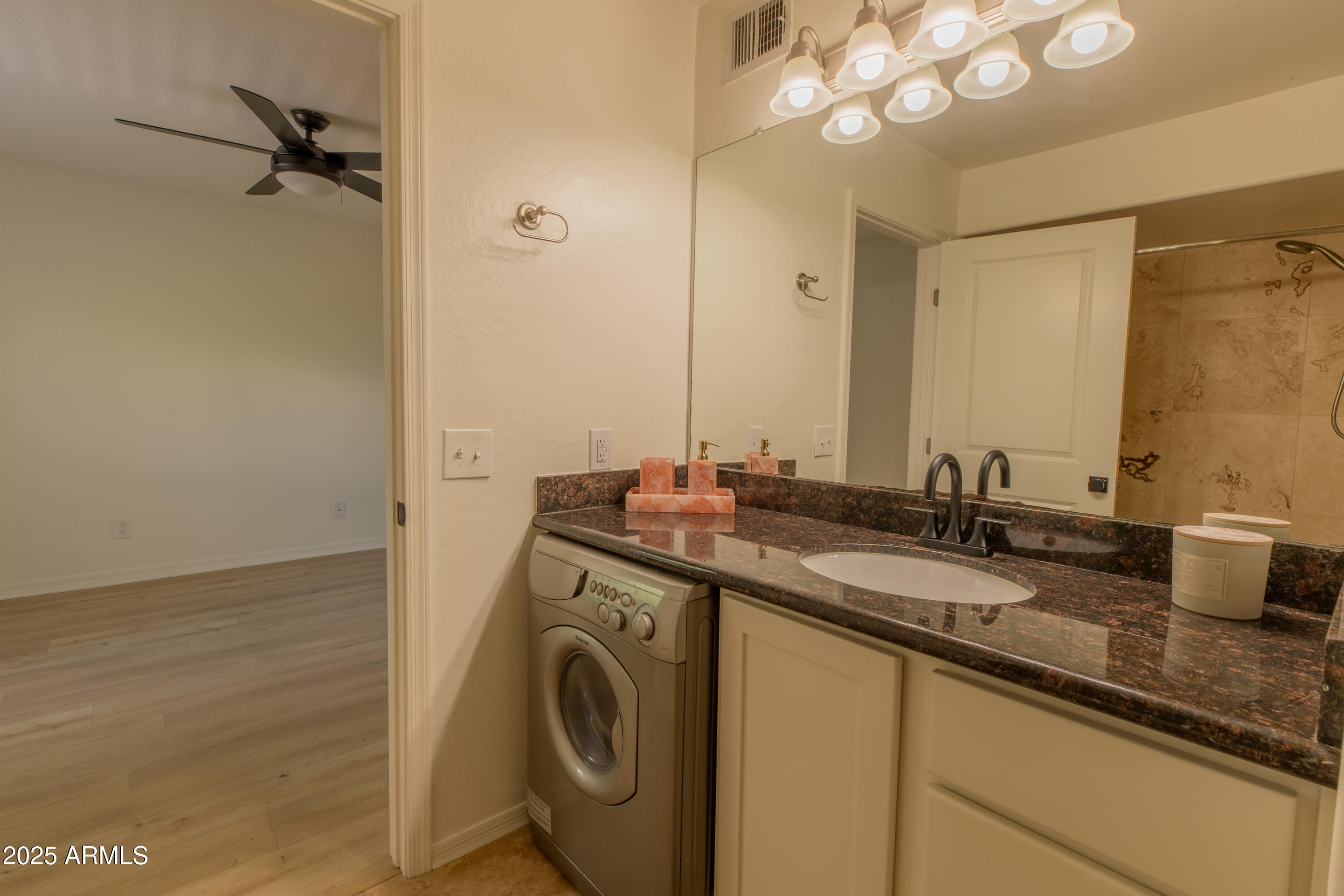 3619 East Monterosa Street, Unit 202 Phoenix, AZ 85018 - Photo 16 of 20 a bathroom with a granite countertop sink a large mirror and a shower
