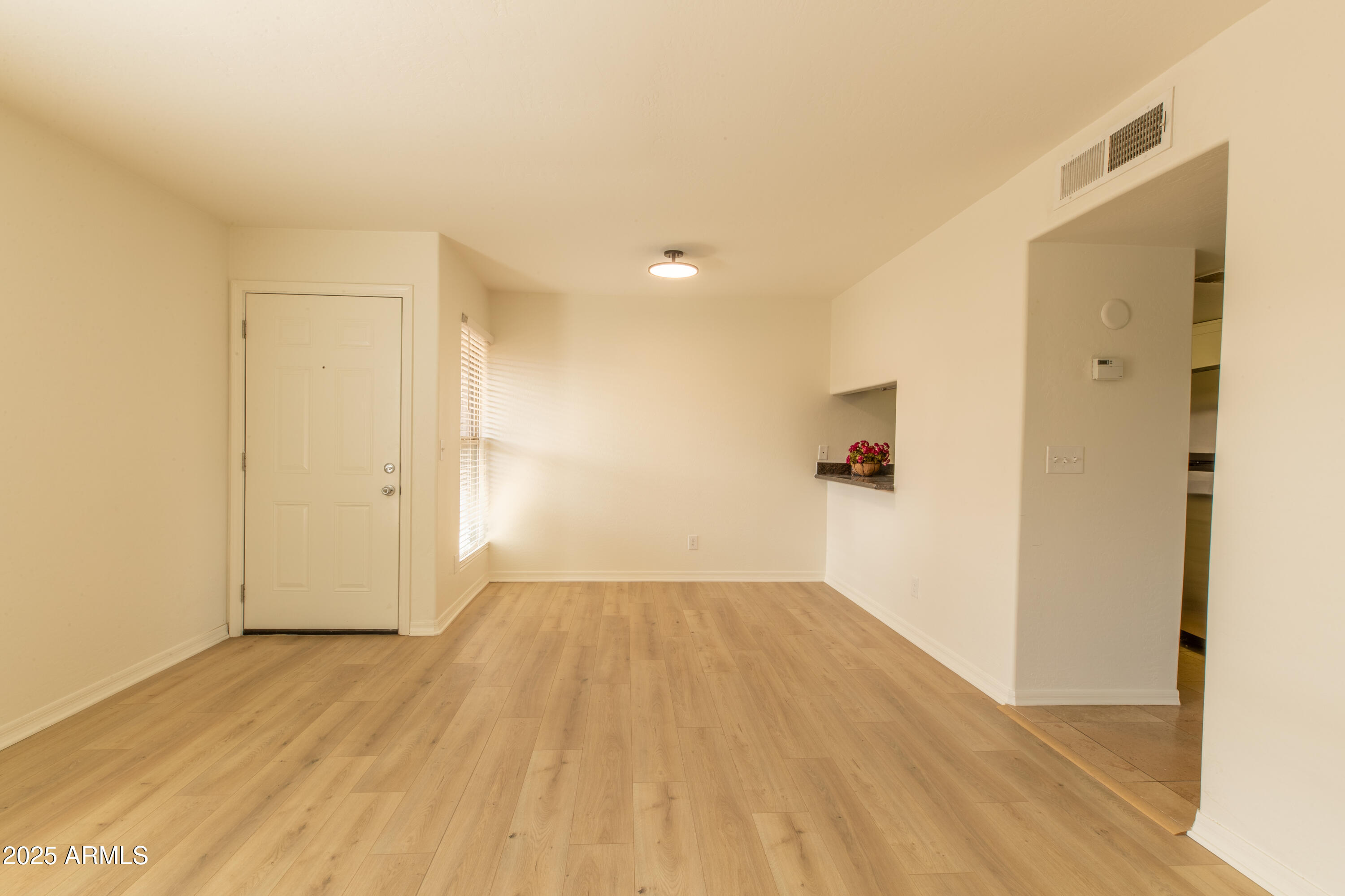 3619 East Monterosa Street, Unit 202 Phoenix, AZ 85018 - Photo 20 of 20 a view of a room with wooden floor and a ceiling fan