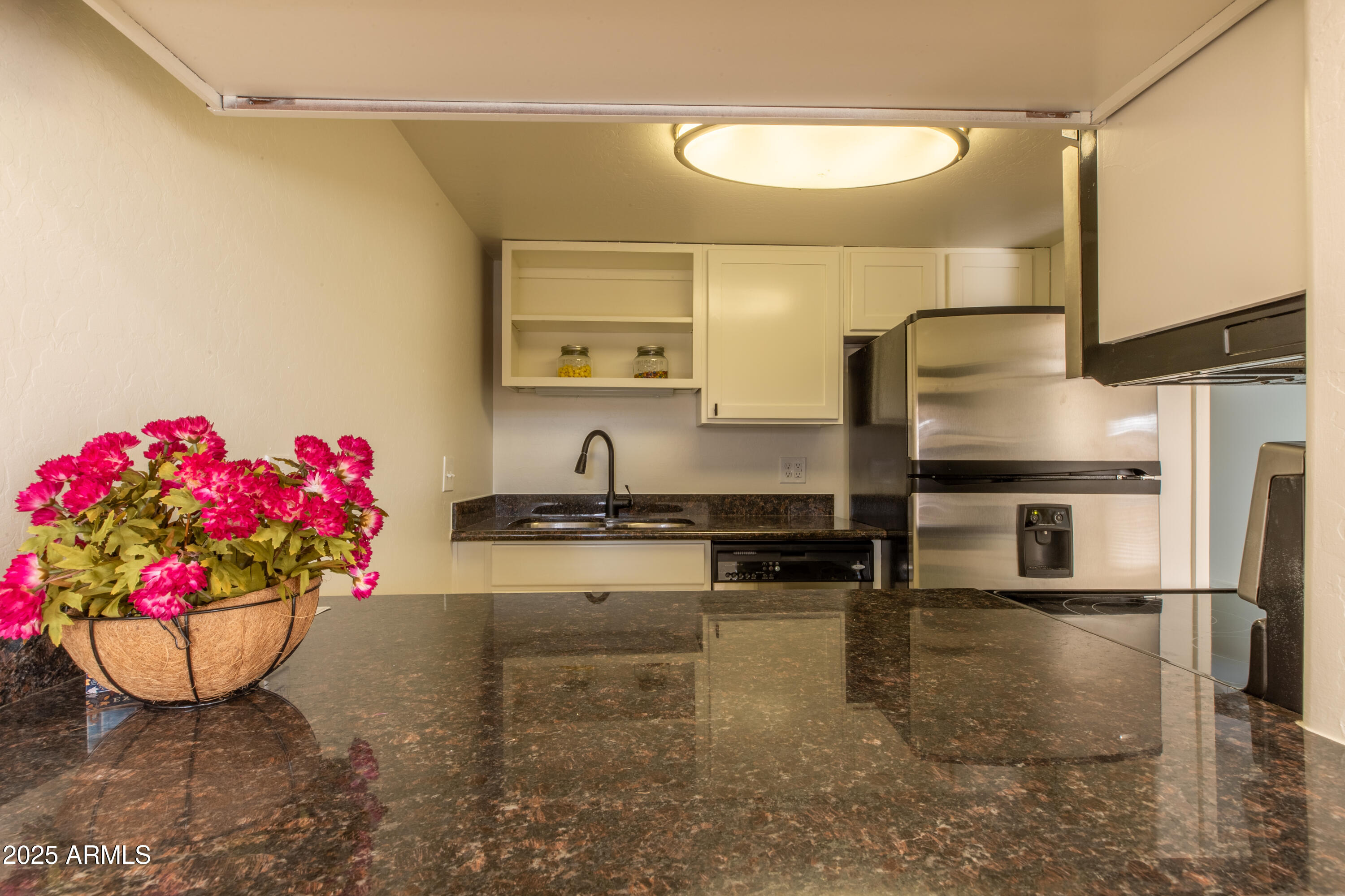 3619 East Monterosa Street, Unit 202 Phoenix, AZ 85018 - Photo 2 of 20 a kitchen with stainless steel appliances granite countertop a sink refrigerator and cabinets