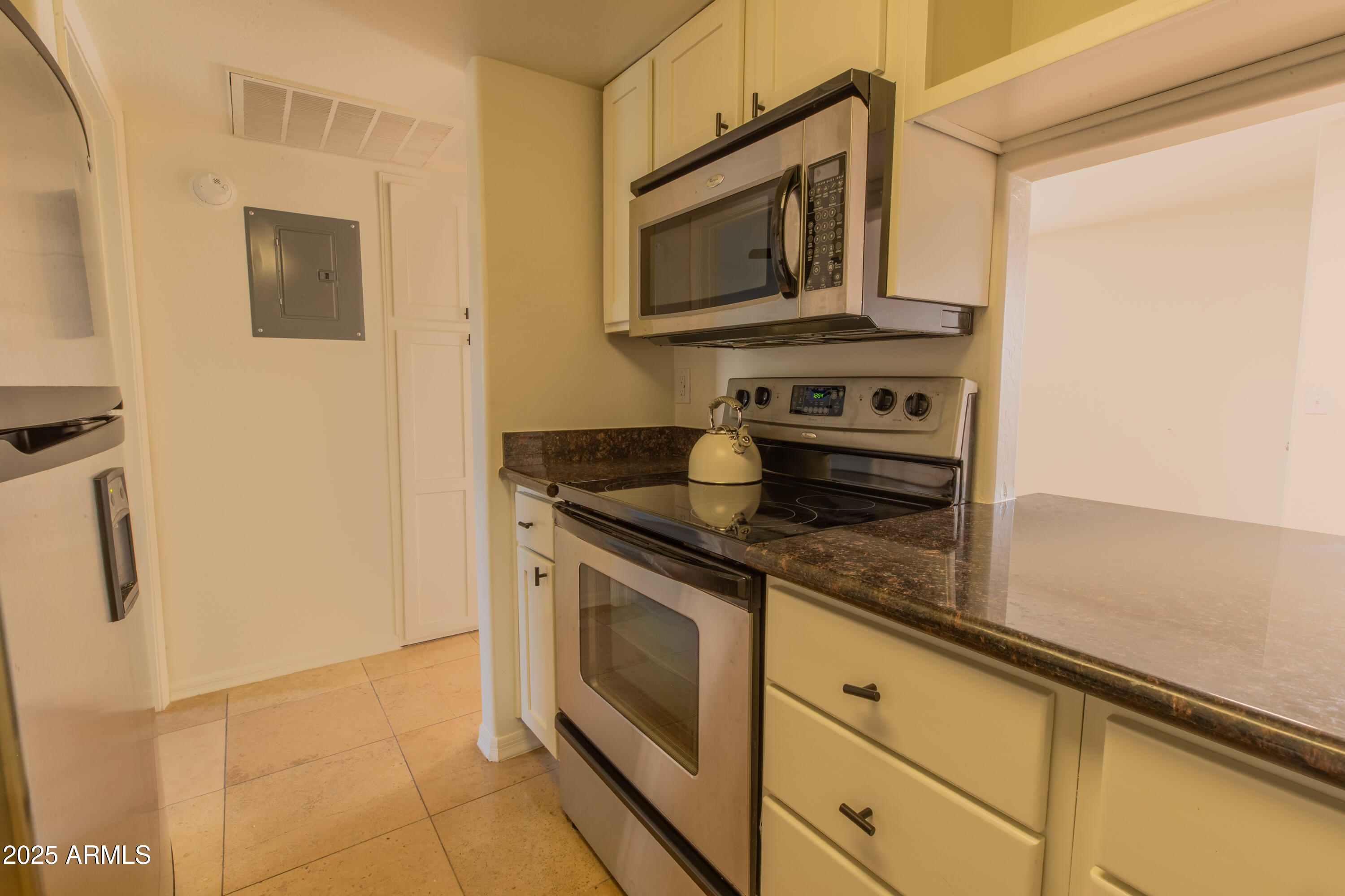 3619 East Monterosa Street, Unit 202 Phoenix, AZ 85018 - Photo 3 of 20 a kitchen with stainless steel appliances granite countertop a stove and a microwave