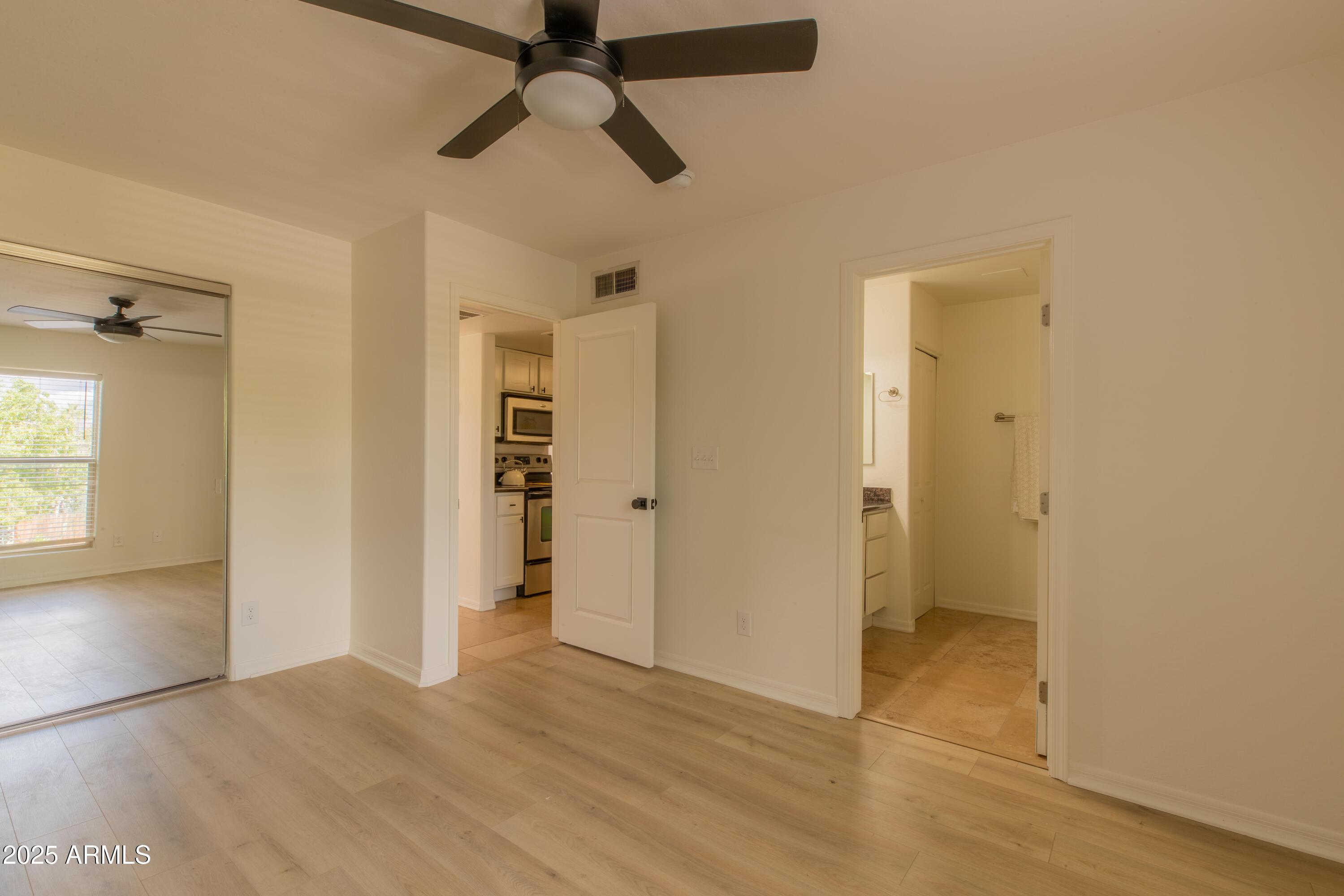 3619 East Monterosa Street, Unit 202 Phoenix, AZ 85018 - Photo 8 of 20 wooden floor in an empty room with a window