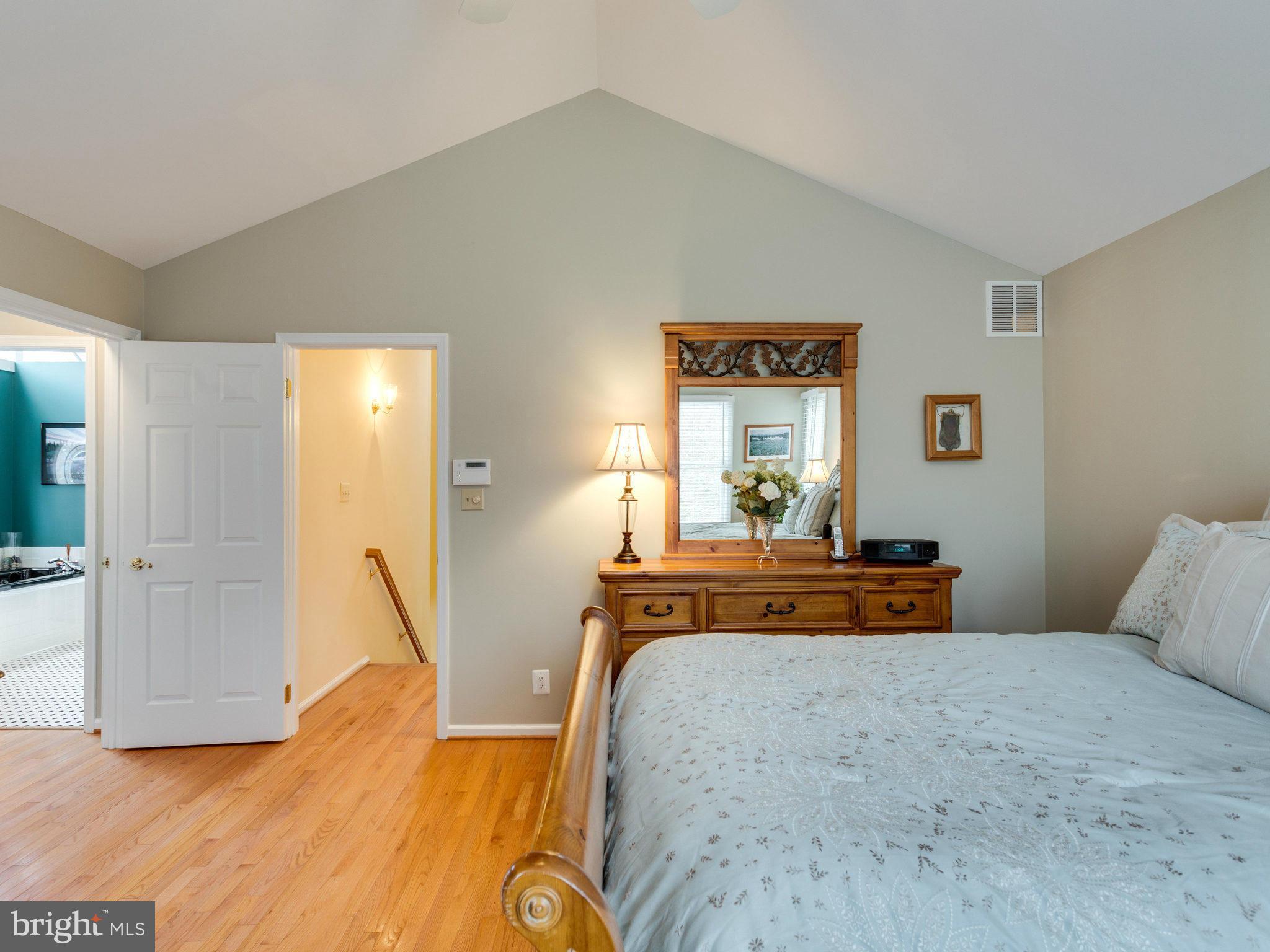 12515 Chapel Road Clifton, VA 20124 - Photo 20 of 30 a bedroom with a bed and wooden floor