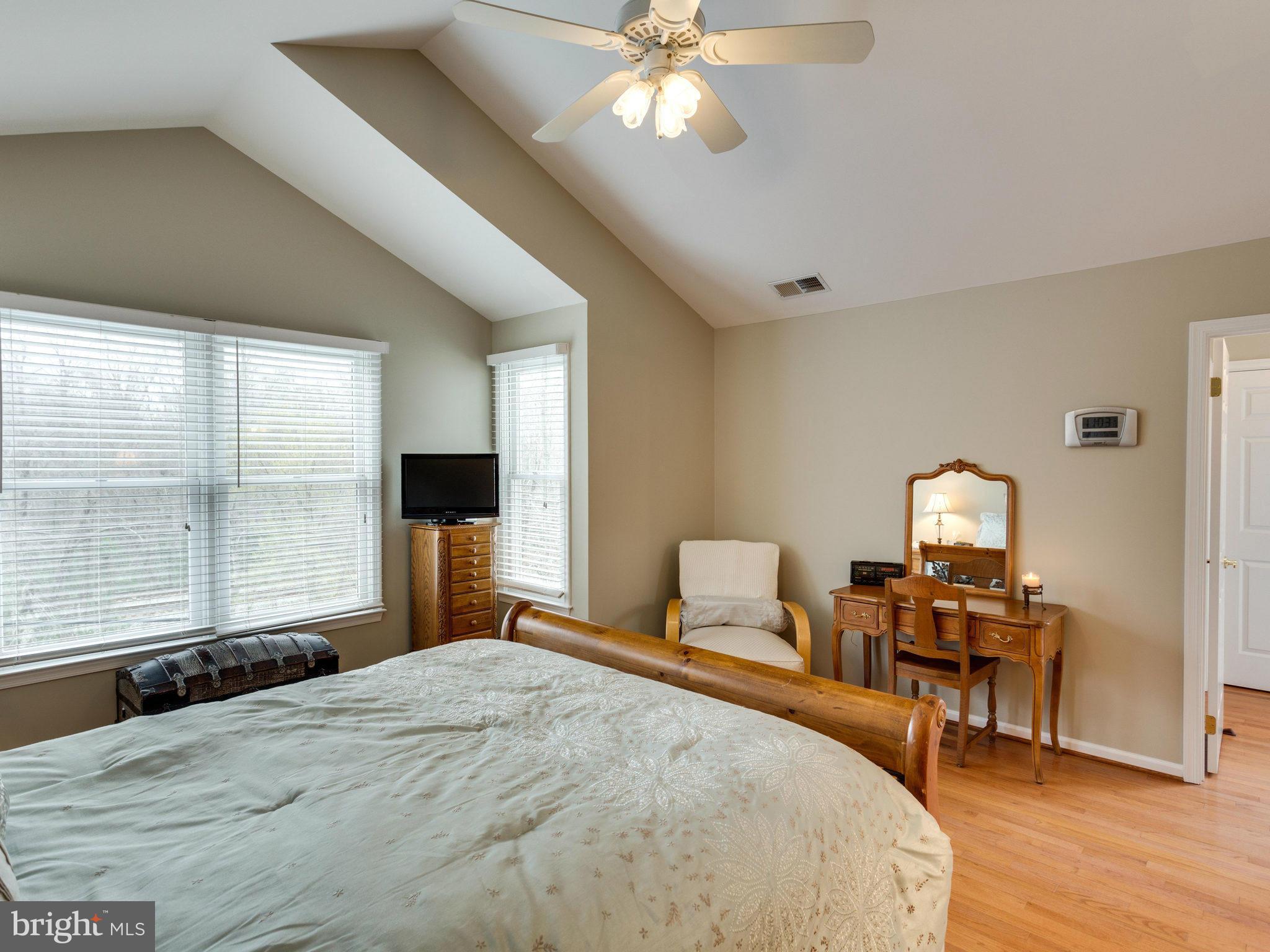 12515 Chapel Road Clifton, VA 20124 - Photo 21 of 30 a bedroom with a bed and a chandelier