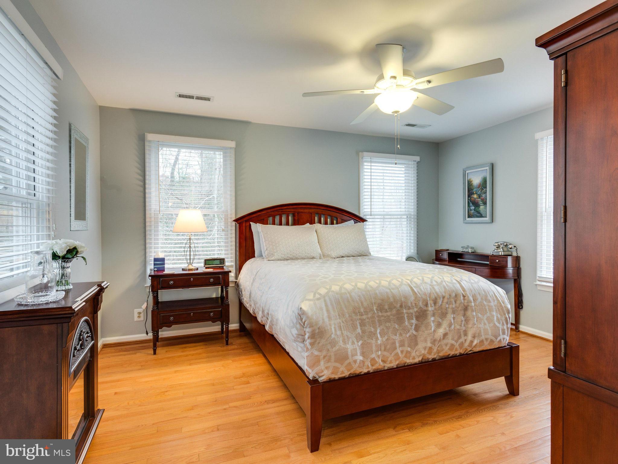 12515 Chapel Road Clifton, VA 20124 - Photo 25 of 30 a bedroom with a large bed and a chandelier