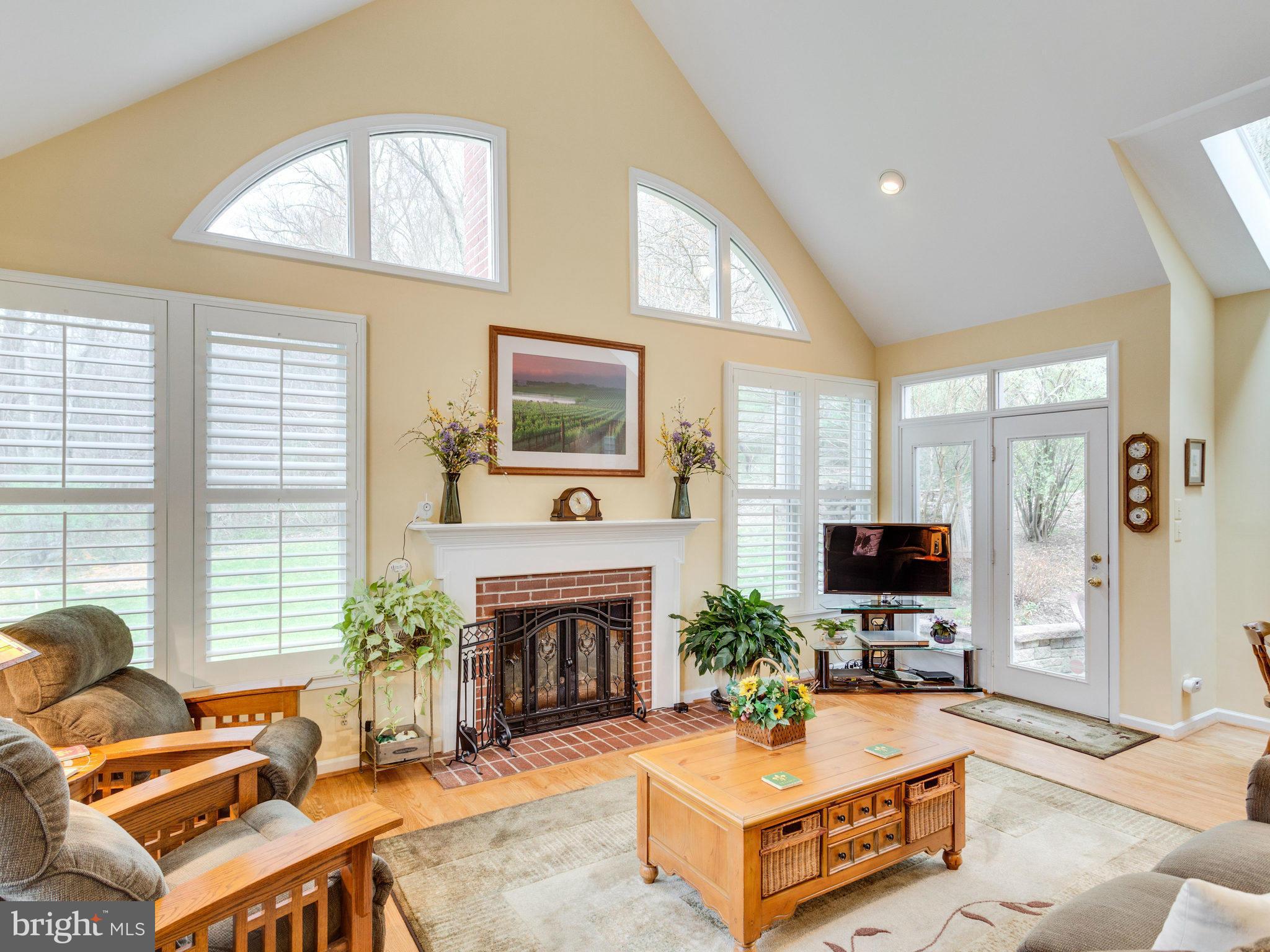 12515 Chapel Road Clifton, VA 20124 - Photo 6 of 30 a living room with furniture a flat screen tv and a fireplace