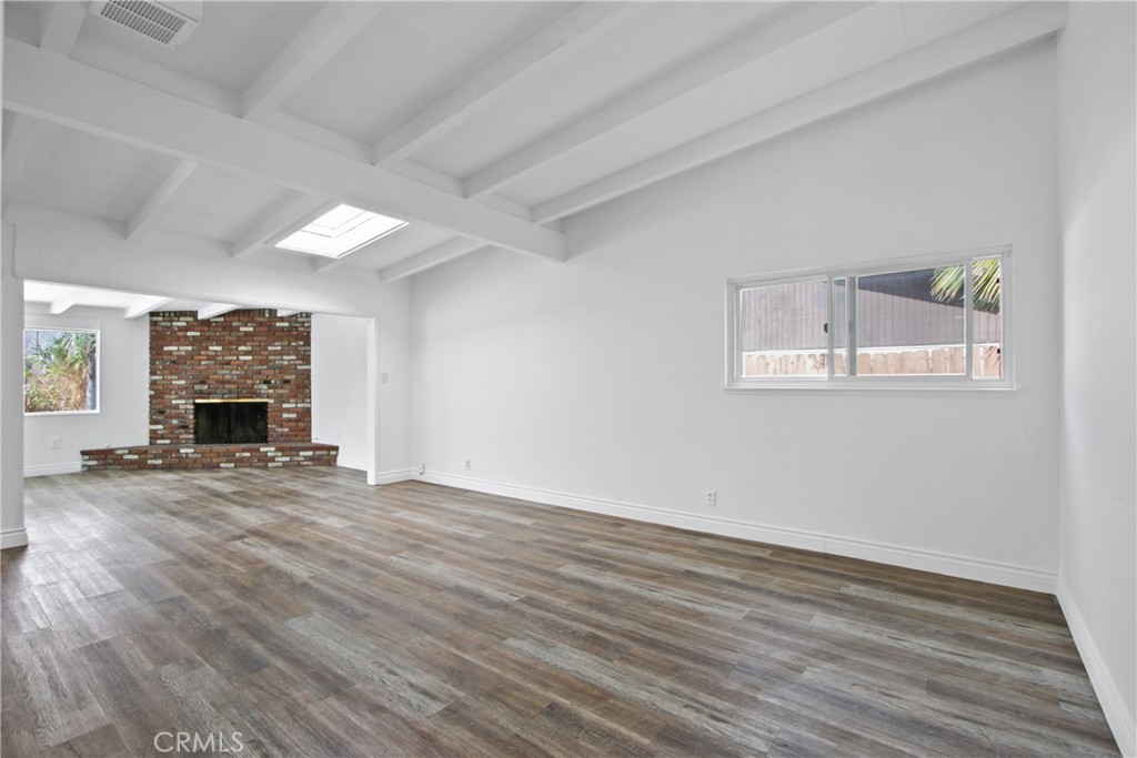 1924 Via Del Rio Corona, CA 92882 - Photo 2 of 15 a view of empty room with wooden floor and fireplace
