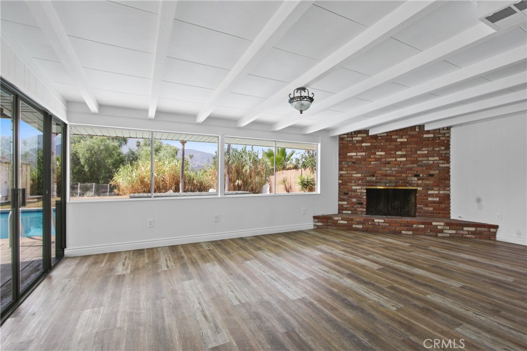 1924 Via Del Rio Corona, CA 92882 - Photo 4 of 15 an empty room with wooden floor fireplace and windows