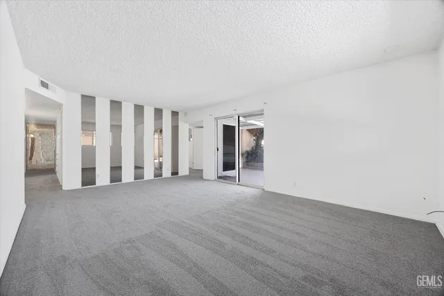 a view of a room with staircase and door