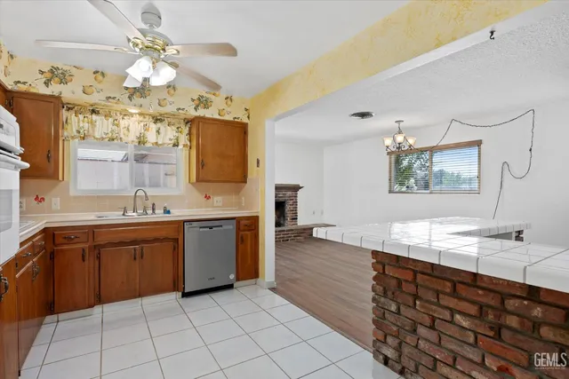 a kitchen with stainless steel appliances granite countertop a sink and cabinets