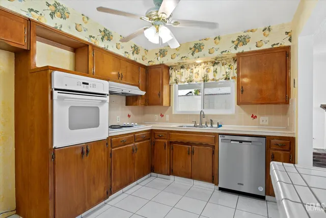 a kitchen with stainless steel appliances granite countertop a sink and cabinets