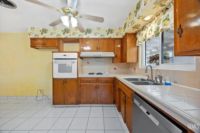 a bathroom with a granite countertop sink a mirror and a bathtub
