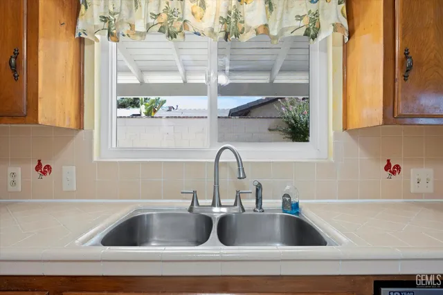 a kitchen with sink cabinets and wooden floor