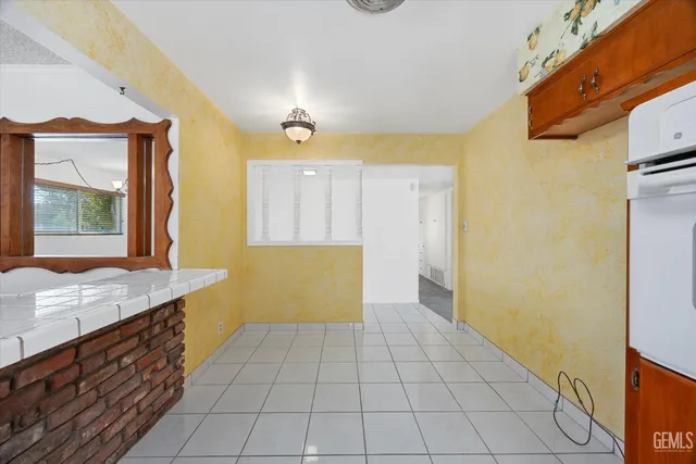 a kitchen with a stove a sink and a refrigerator