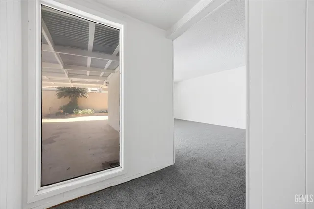 an empty room with closet and wooden floor