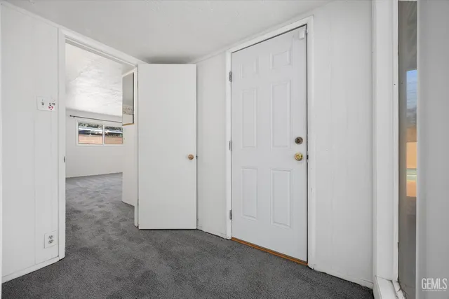 a bathroom with a granite countertop sink mirror and a toilet