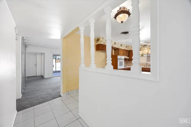 a view of a kitchen with furniture and an empty room