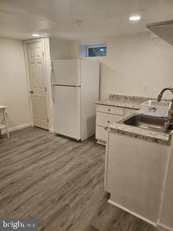 a kitchen with a refrigerator and a sink