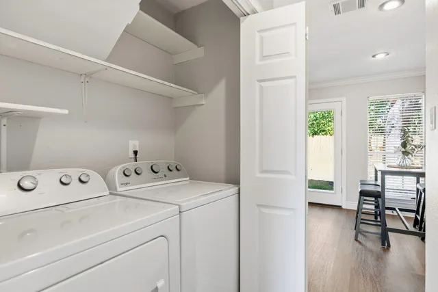 a view of washer and dryer with wooden floor