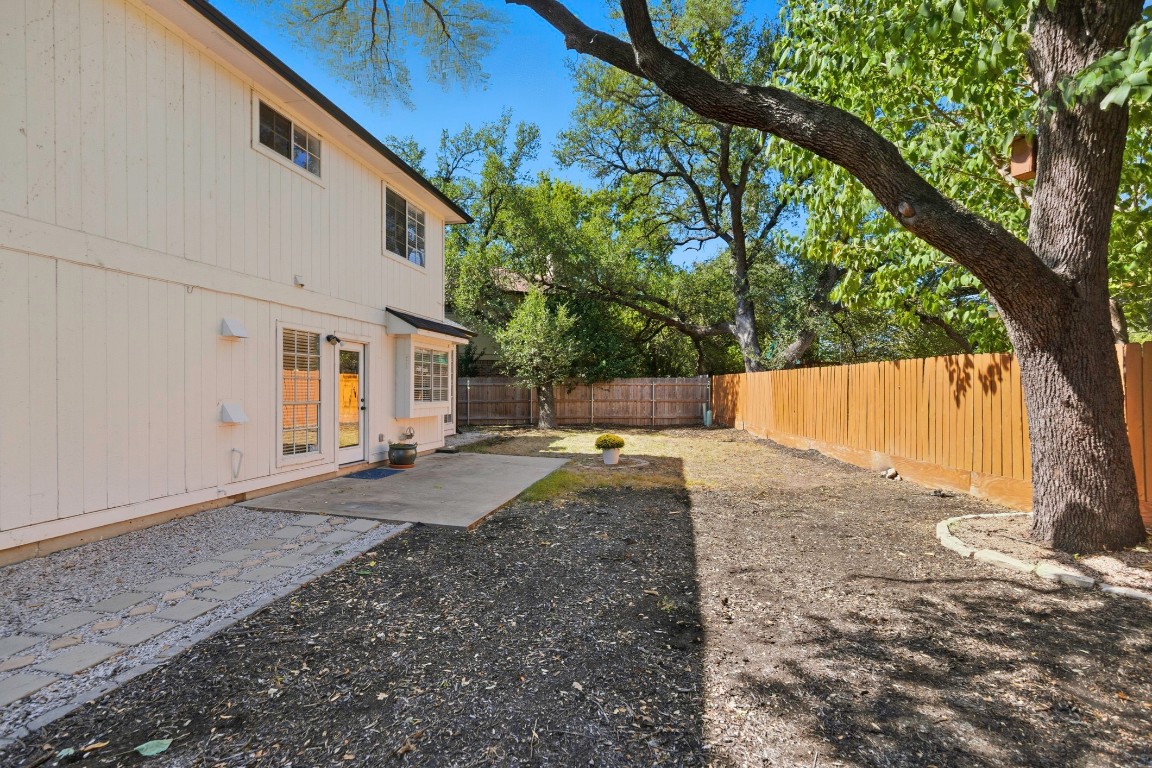 1108 Red Bird Drive Cedar Park, TX 78613 - Photo 27 of 30 a view of a backyard with large trees and a small barn