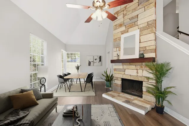a living room with furniture a fireplace and a potted plant