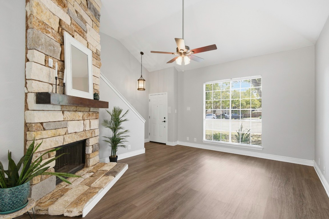 1108 Red Bird Drive Cedar Park, TX 78613 - Photo 6 of 30 a view of an empty room with wooden floor fireplace and a window