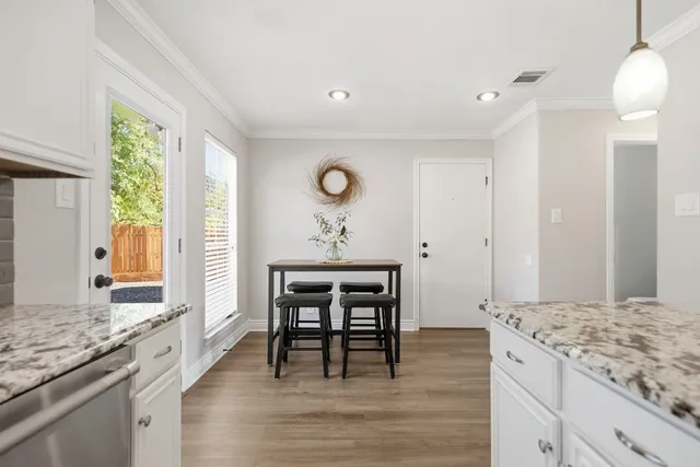 a view of kitchen island with furniture wooden floor dining table and chairs