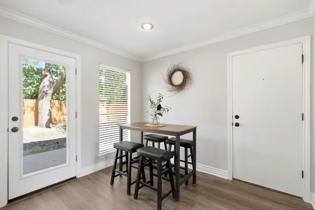 a view of a dining room with furniture and wooden floor