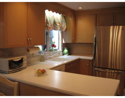 18 Preston Beach Road Marblehead, MA 01945 - Photo 3 of 11 a kitchen with stainless steel appliances granite countertop a sink refrigerator and microwave