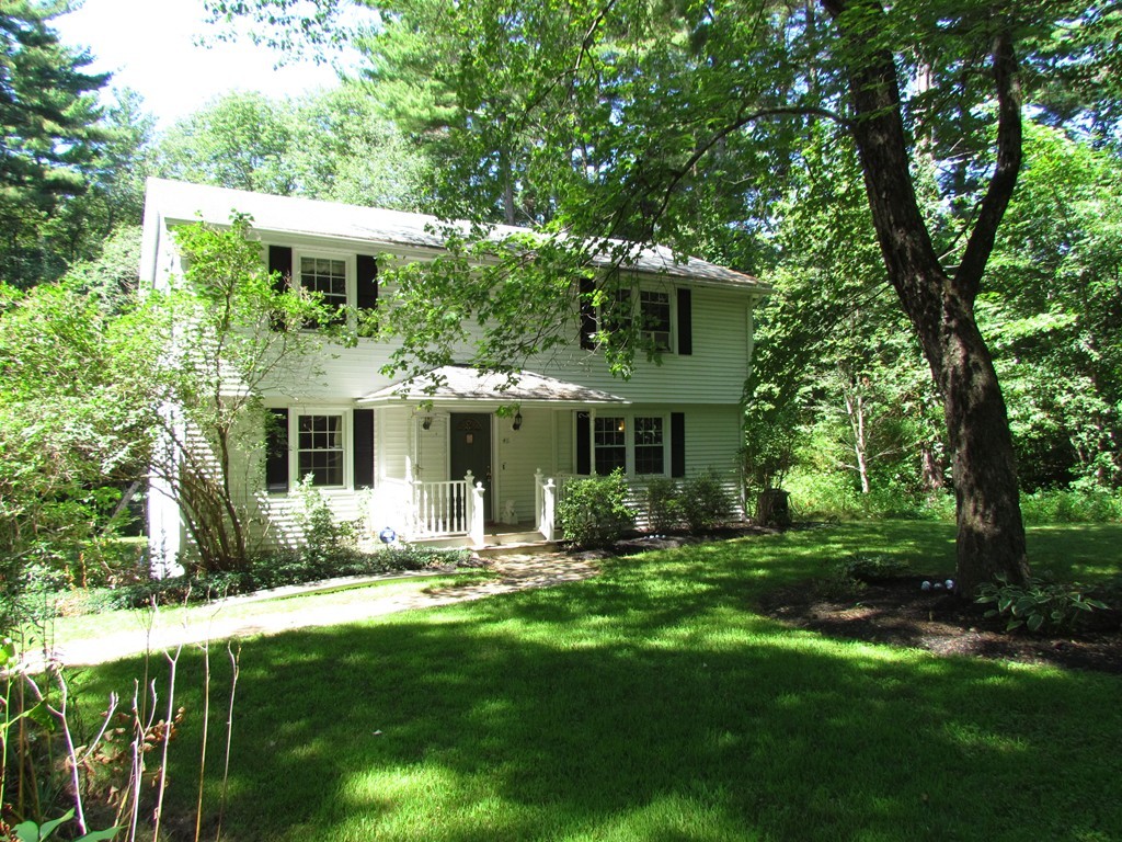 46 Old Mill Road Sutton, MA 01590 - Photo 1 of 23 a front view of a house with a yard table and chairs