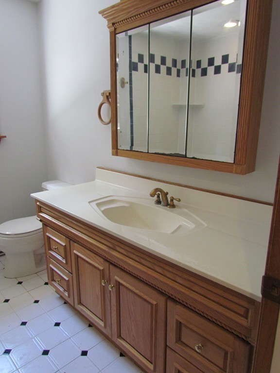 46 Old Mill Road Sutton, MA 01590 - Photo 17 of 23 a bathroom with a sink and mirror