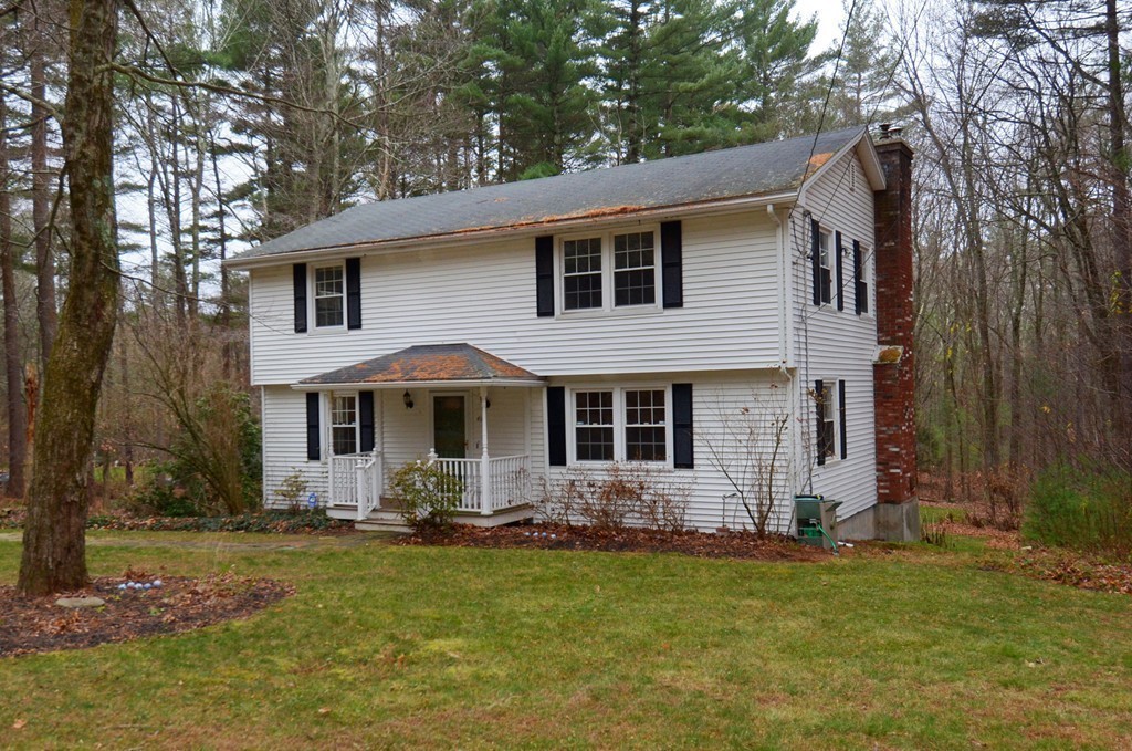 46 Old Mill Road Sutton, MA 01590 - Photo 2 of 23 a front view of a house with a garden