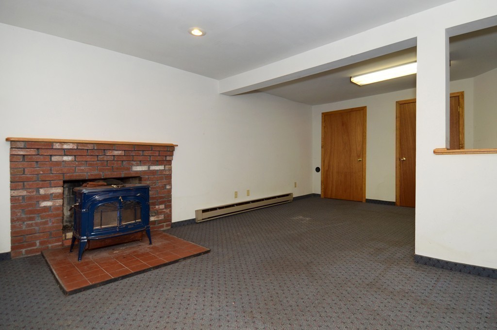 46 Old Mill Road Sutton, MA 01590 - Photo 21 of 23 a living room with furniture and a fireplace