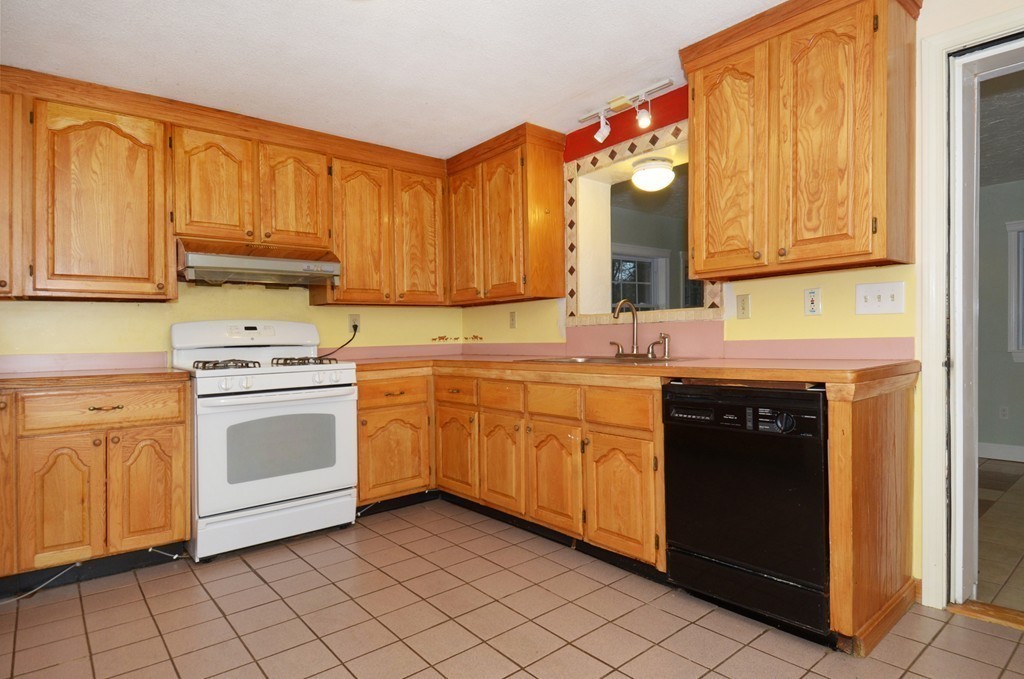 46 Old Mill Road Sutton, MA 01590 - Photo 5 of 23 a kitchen with white cabinets sink and white appliances