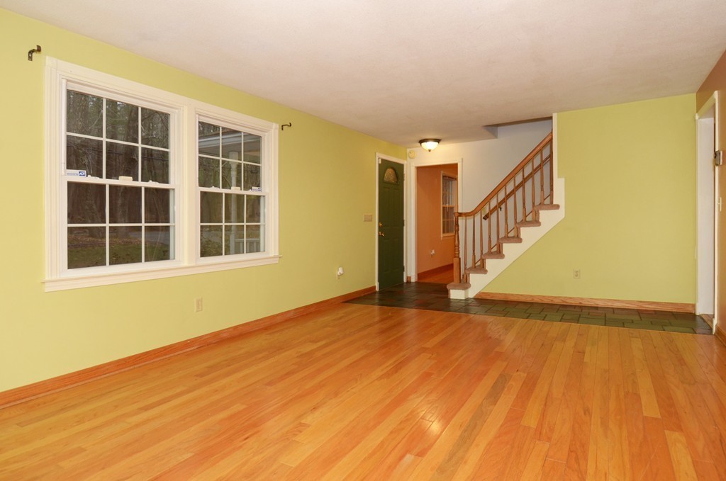 46 Old Mill Road Sutton, MA 01590 - Photo 7 of 23 a view of an empty room with wooden floor and a window