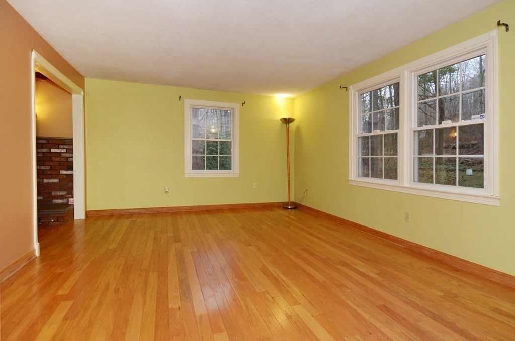 46 Old Mill Road Sutton, MA 01590 - Photo 8 of 23 a view of an empty room with wooden floor and a window