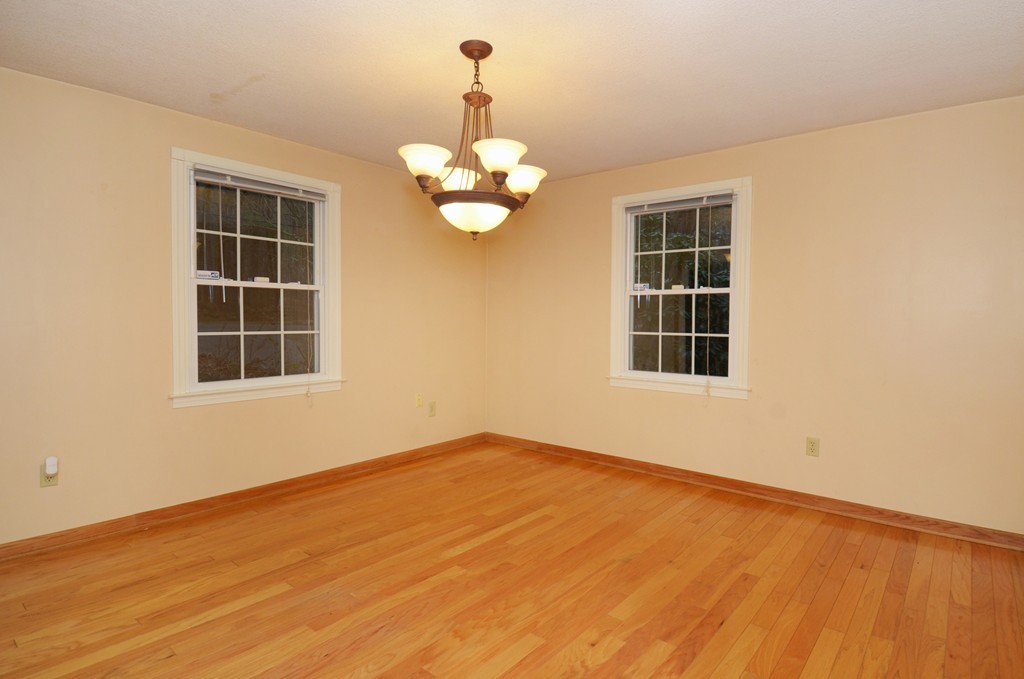 46 Old Mill Road Sutton, MA 01590 - Photo 9 of 23 a view of an empty room with a window and chandelier fan