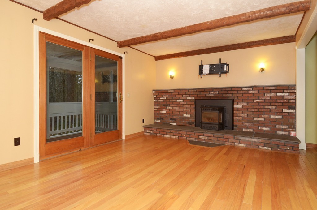46 Old Mill Road Sutton, MA 01590 - Photo 10 of 23 a view of empty room with wooden floor and fireplace