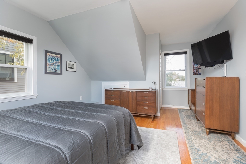 59 Florence Road Waltham, MA 02453 - Photo 11 of 20 a bedroom with a bed and a flat screen tv