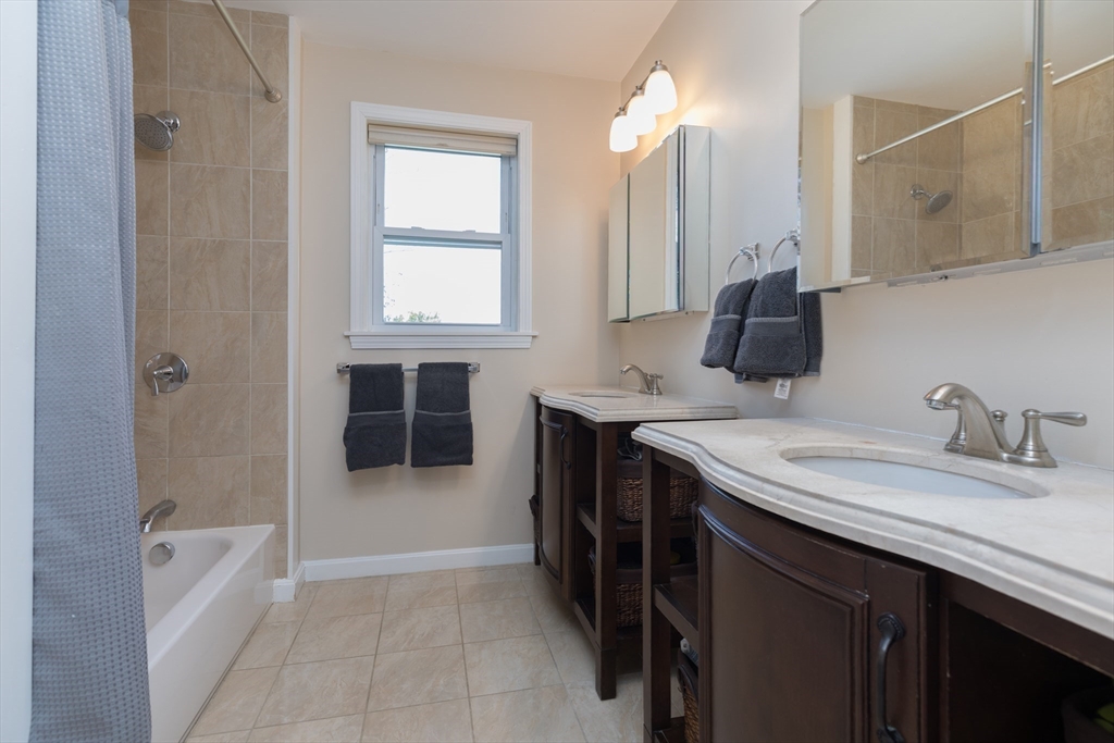 59 Florence Road Waltham, MA 02453 - Photo 12 of 20 a bathroom with a sink a vanity and a mirror