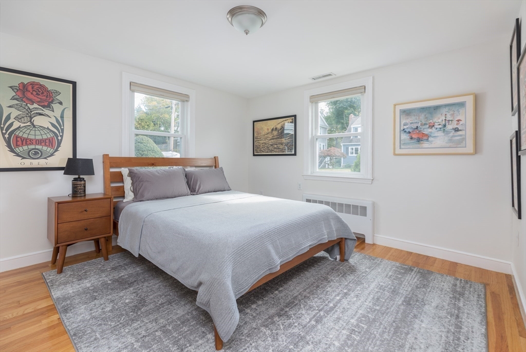 59 Florence Road Waltham, MA 02453 - Photo 13 of 20 a bedroom with a bed and painting on the wall